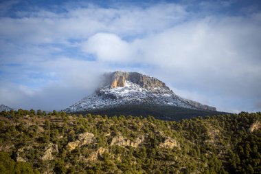 Top of a snowy mountain illuminated by the morning sun in the Regional Park of Sierra Espuna, in the Region of Murcia, Spain