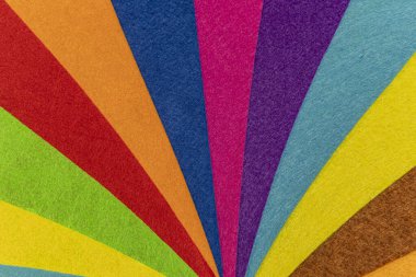 Texture created with overlapping pieces of felt creating a multicolored rainbow of curved lines that look like a circus tent