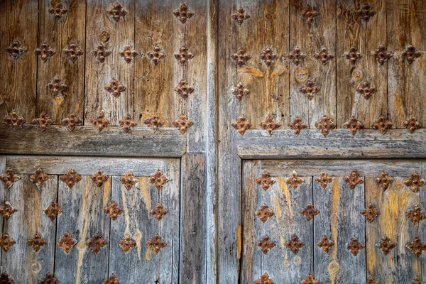 e-worn solid wooden door with decorative metal elements