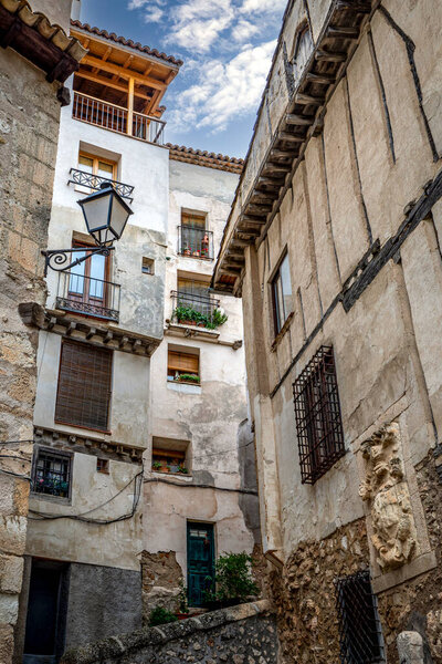 Alley with tall and narrow medieval buildings of the world heritage old town of Cuenca, Spain
