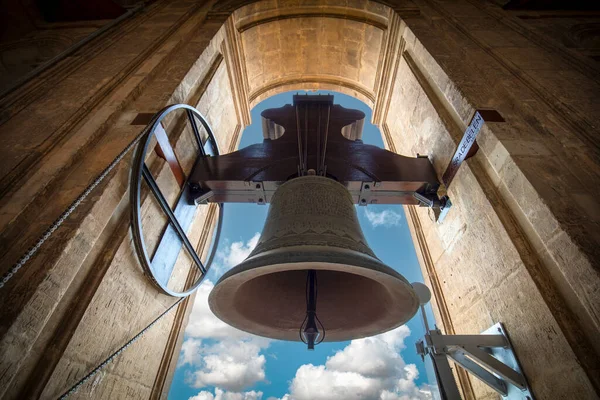 Bell tower of the cathedral of Murcia, Spain, with blue sky and clouds in the background