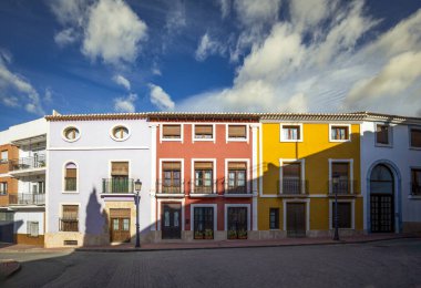 Typical facades of different colors of the Plaza Vieja in Alhama de Murcia, Region of Murcia, Spain clipart