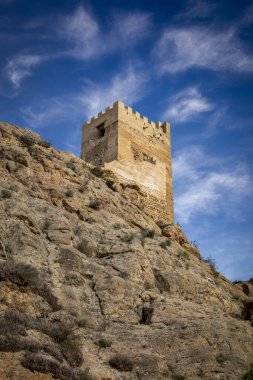 Crenellated Tower of Homenaje of the medieval castle of Alhama de Murcia, Region of Murcia, Spain, on a high cliff clipart