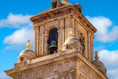 Detail of the bell tower of the parish of El Salvador, Caravaca, Murcia, Spain, in Renaissance style over blue sky clipart