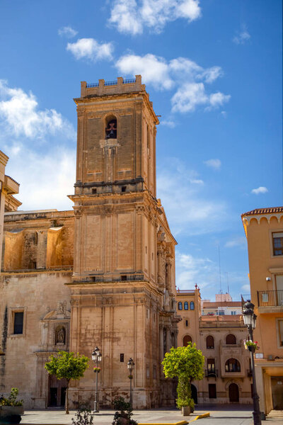 Vertical view of the baroque Basilica of Santa Mara in Elche, Alicante, Valencian Community, Spain, with the midday sun shining overhead