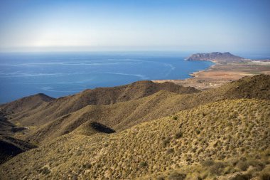 View from a viewpoint of the Puntas de Calnegre regional park in the Region of Murcia, Spain with its coves and arid landscape clipart