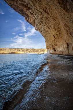 Vertical photo of Cala Blanca beach under a cave in the Puntas de Calnegre regional park in Lorca, Region of Murcia, Spain clipart