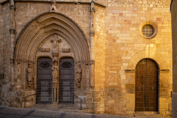 Facade of the parish church of Santa Maria del Salvador in Chinchilla de Montearagon, Albacete, Castilla-La Mancha, Spain in Gothic style and morning light
