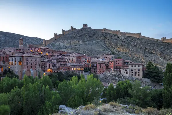 stock image Panoramic view of Albarracn, Teruel, Aragon, Spain, illuminated at dusk, with the old town and walls on the hill