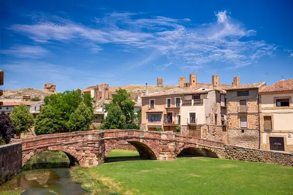 stock image View of the town of Molina de Aragn, Guadalajara, Castilla-la Mancha, Spain, with its medieval bridge, the old town and the castle walls and towers in the background