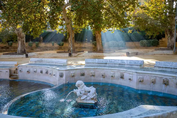 stock image Detail of a sculpture of the King's fountain, with morning mist and light between the trees. Priego de Cordoba, Cordoba, Andalusia, Spain