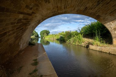 View of the Canal de Castilla from under a bridge at Fromista, Palencia, Castilla y Leon, Spain with early morning light clipart