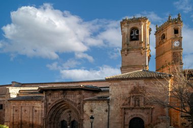 View of Church of the Santisima Trinidad of Alcaraz, Albacete, Castilla la Mancha, Spain, with the Tardon tower in the background clipart