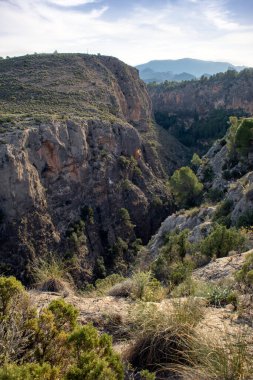 Vertical view of a section of the Segura River as it passes through the impressive Almadenes Canyon, Cieza, Region of Murcia, Spain clipart