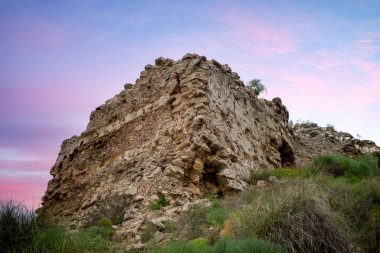 Puentes Kalesi 'nin kalıntıları ve kalıntıları gün batımında İspanya' nın Lorca, Murcia Bölgesi 'nde aynı isimli bir tepede yer alıyor.