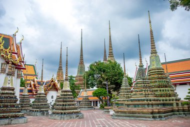 Wat Pho 'da renkli bir çedi grubu ya da Tayland, Bangkok' taki yaslanan Buda Tapınağı, ağaçların arasında.