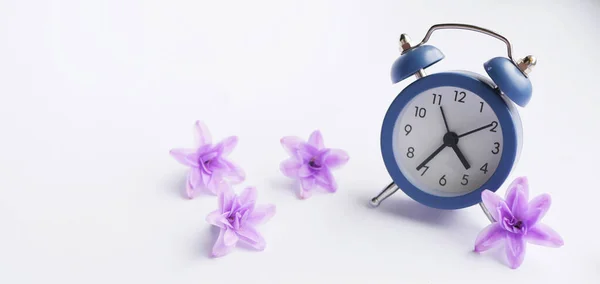 Clock with flower blossom. Spring time banner