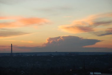 Horizon at sunset. Abstract city landscape background. Red sky with clouds over the city, beautiful panoramic view.