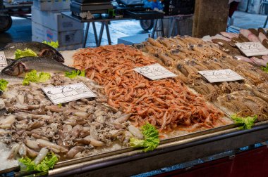 Venice, Italy- Feb 23, 2023: Fresh fish displayed at The Rialto Fish Market in Venice, Italy. clipart