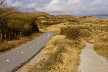 Bicycle and walking path on the dunes at the North Sea shore, Katwijk, Netherlands clipart