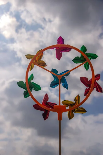 stock image Colorful pinwheel against cloudy and blue sky