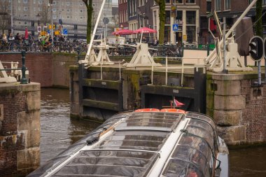 Hollanda, Amsterdam 'ın kanallarından geçen bir tekne.