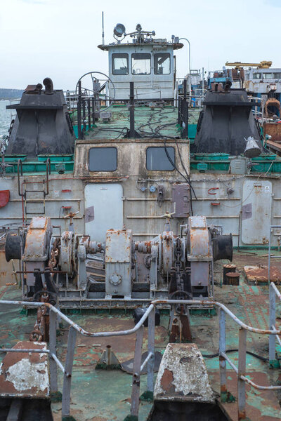 Old river vessels rust on dock repair shop