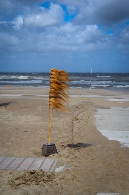 Noordwijk beach decoration, waves, sand and wind clipart