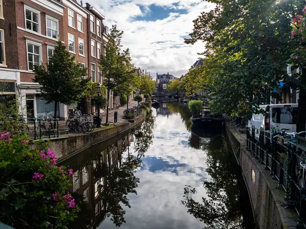 stock image 13.09.2024  Leiden, Netherlands, Leidens canals, lined with historic Dutch buildings and lush greenery, reflect the serene beauty of the city. The calm waters and picturesque architecture create a tranquil urban scene.