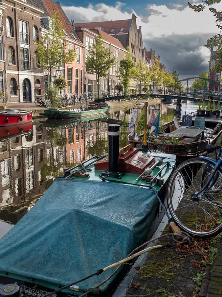 stock image 13.09.2024  Leiden, Netherlands, Leidens canals, lined with historic Dutch buildings and lush greenery, reflect the serene beauty of the city. The calm waters and picturesque architecture create a tranquil urban scene.