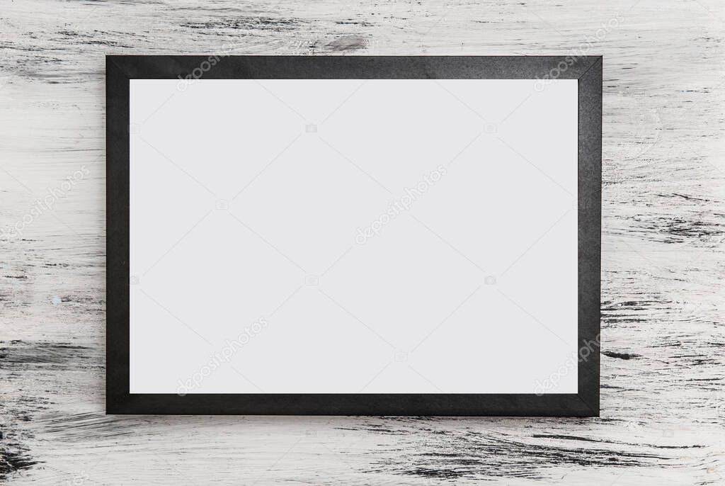 Black frame for text with white letter on light wood