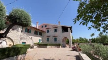 Courtyard of a stone house with terraces and shutters on the windows. High quality 4k footage