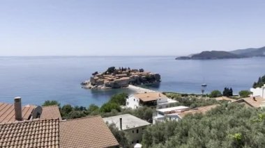 View of the island of Sveti Stefan above the rooftops. High quality 4k footage