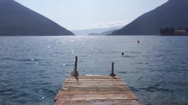 View from the wooden bridge to the sea, mountains and the island of St. George. Montenegro. High quality FullHD footage