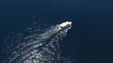 Excursion boat sails along the sea past the coast of Perast. Montenegro. High quality 4k footage
