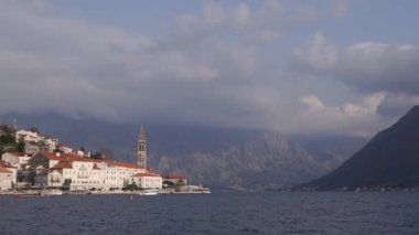 Tower of the church of St. Nicholas rises above the old houses of Perast. Montenegro. High quality FullHD footage
