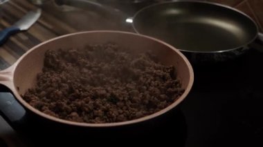 Steam rises over stewing minced meat in a frying pan. High quality 4k footage