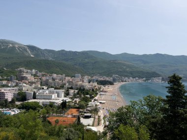 Coast of Budva with modern hotels and sandy beaches by the sea against the backdrop of mountains. High quality photo