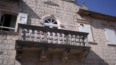 Balcony with carved balustrade on an old stone house. High quality FullHD footage