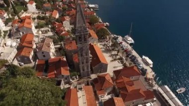 Ancient bell tower of the church on the shore of the Bay of Kotor. Drone. High quality 4k footage