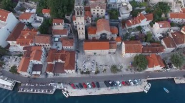 Church of St. Nicholas with a bell tower in Perast at the foot of the green mountains. Montenegro. High quality 4k footage