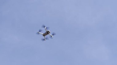 Four-engine drone soars in the air. High quality FullHD footage