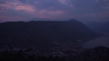 Dark sunset sky over a mountain range and a sea valley. Panorama. High quality FullHD footage