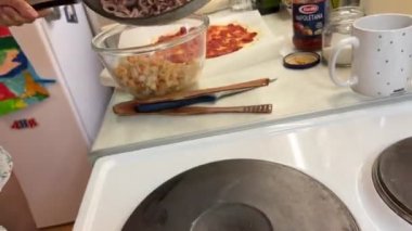 The cook transfers the ingredients from the hot pan to the bowl. High quality 4k footage