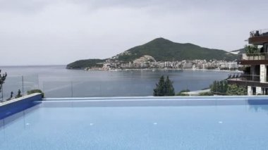 Swimming pool with turquoise water near a modern hotel by the sea. High quality 4k footage