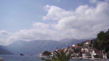 Bird flies over the coast of Perast. Montenegro. High quality FullHD footage