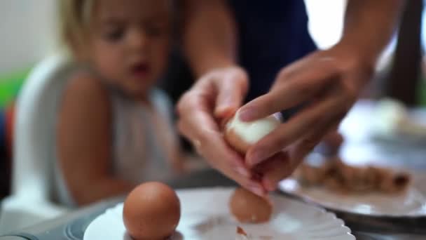 Mom Cleans Shell Boiled Egg Little Girl Sitting Table High — Vídeos de Stock