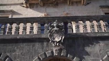 Ancient stone coat of arms on a balcony with a balustrade of an old building. High quality FullHD footage