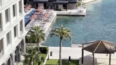 Private beach with sun loungers and covered deck chairs by the sea. High quality 4k footage