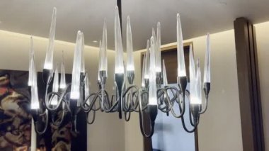 Chandelier with wavy branches and oblong lamps. High quality 4k footage